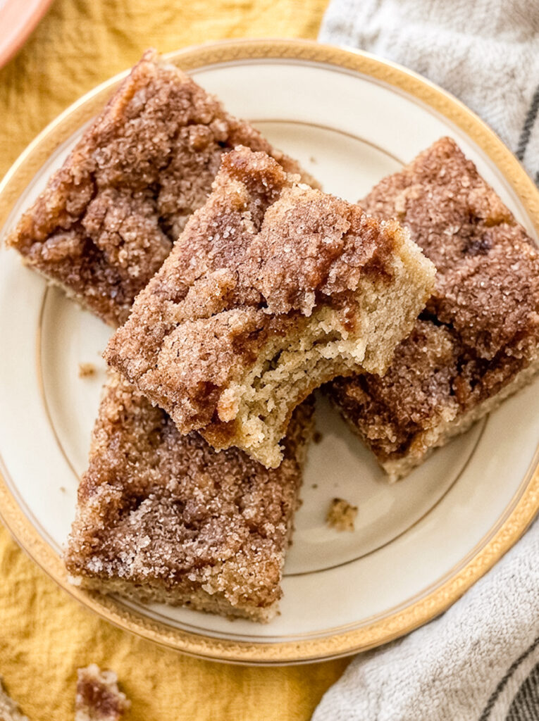 Banana snickerdoodle bars topped with cinnamon sugar on a plate.