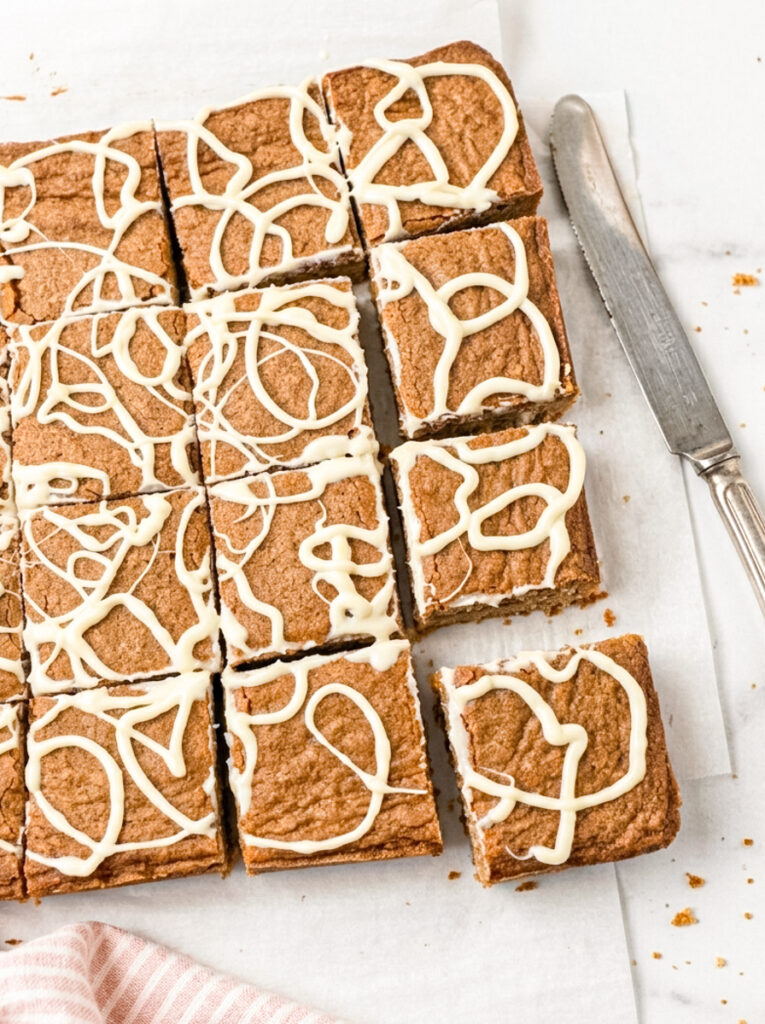 Dirty chai blondies cut into squares and drizzled with white icing.